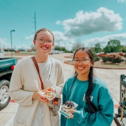 two girls holding food