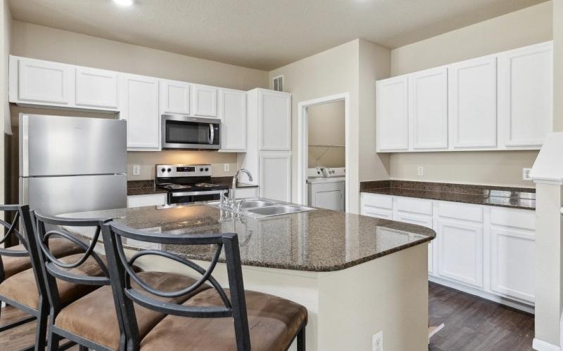 a kitchen with white cabinets