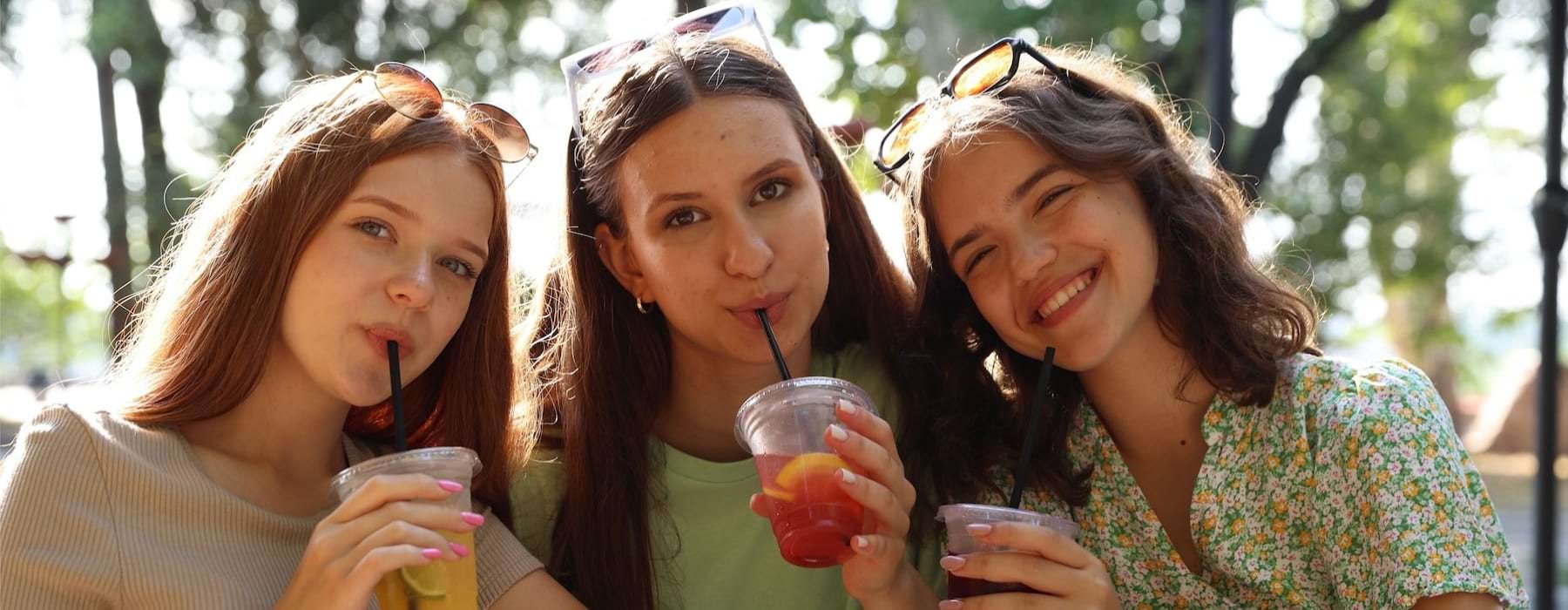 a group of women drinking from a glass