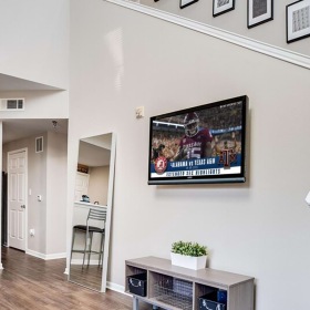 a room with a television and chairs