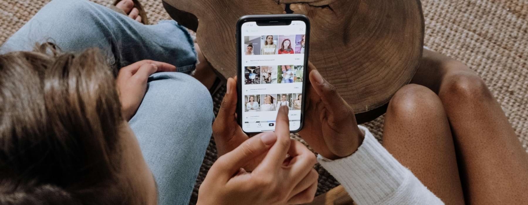 two people looking at a phone